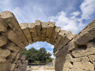 Olympia, Greece - July 4, 2024: Birthplace of the Olympic Games. Ancient stone bow above the...