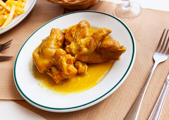 Traditional Spanish braised pettitoes, spicy pig feet cooked with sauce..