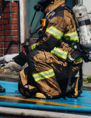 Fototapeta premium Group of South Korean fire men during fire fighting operation in the streets, firefighters with fire engine truck vehicle, 911 emergency and rescue, fire drill, exercise training, Busan, South Kore