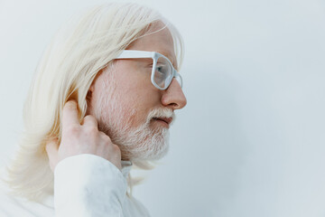 elderly man with long white hair and glasses against a soft white background, showcasing wisdom and...