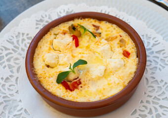 Flan de legumes et feta. Rustic pie with vegetables and cheese served on clay pot on table