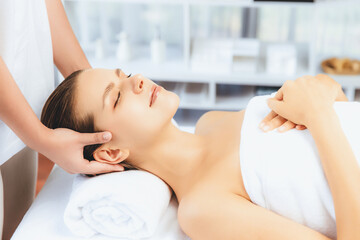 Obraz premium Caucasian woman enjoying relaxing anti-stress head massage and pampering facial beauty skin recreation leisure in dayspa modern light ambient at luxury resort or hotel spa salon. Quiescent