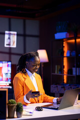 Obraz premium Gen Z young woman using debit card, adding payment method on website, enjoying sales period. African american teenager doing internet shopping, typing credit card information on laptop display
