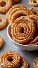 Fototapeta premium Indian Traditional Snack Chakli, a spiral shaped crisp deep fried snack, It is known as Chakali, Murukku, Chakri in Gujarat, Chakli in Maharashtra and Northern India