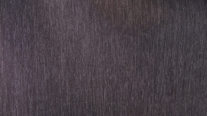 Close-up of a dark gray denim fabric texture.