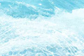Blue water with ripples on the surface. Defocus blurred transparent blue colored clear calm water surface texture with splashes and bubbles. Water waves with shining pattern texture background.
