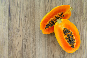 Papaya fruit on light wooden background. Slices of sweet papaya on wooden background, Halved papayas