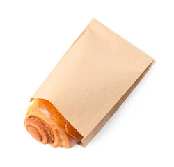 Paper bag with freshly baked bun isolated on white, top view