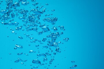 Many water bubbles on blue background, closeup. Space for text