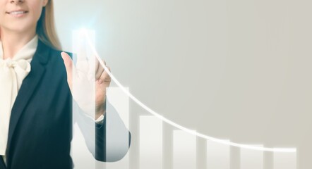Young businesswoman using virtual screen with chart on grey background
