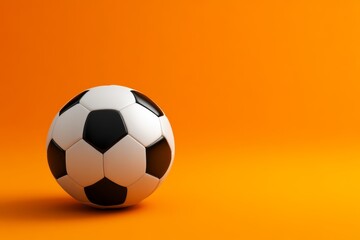 Naklejka premium Soccer ball is sitting on a bright orange background