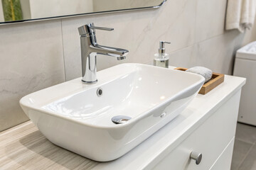 Fototapeta premium Modern bathroom sink with sleek faucet and minimalist design