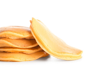 Tasty pumpkin pancakes on white background