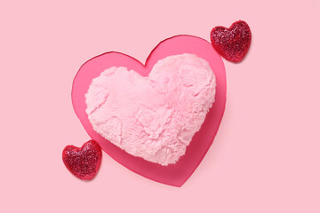 Composition with heart-shaped cushion and decor for Valentine's Day celebration on pink background
