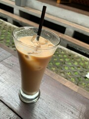 a glass of Spanish latte cortado with ice and a nice cold coffee taste in minimal style cafe, Cool summer drink.
