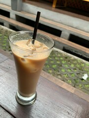 a glass of Spanish latte cortado with ice and a nice cold coffee taste in minimal style cafe, Cool summer drink.