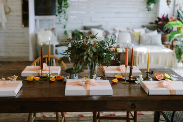 Beautifully arranged festive table setting with floral centerpiece and elegant packages for a special gathering