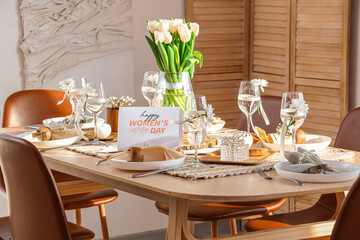 Dining table with setting and beautiful tulip flowers served for International Women's Day celebration