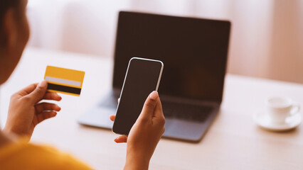 E-Commerce Concept. Over The Shoulder View Of African American Woman Shopping Online Using...