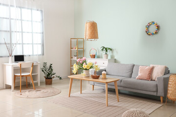 Modern living room with Easter basket and cake on table