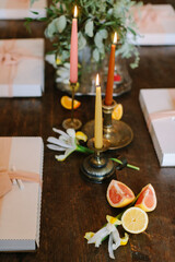 Elegant table setting with candles and fresh fruits for a special gathering in cozy indoor space