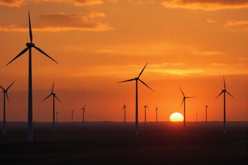 Obraz premium Majestic Sunset Silhouette of Wind Turbines Generating Clean Energy