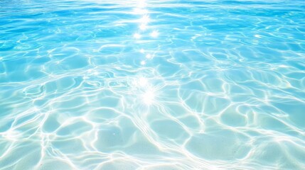 Obraz premium Sunlight is reflecting and creating beautiful patterns on the surface of clear turquoise water gently rippling in the wind, offering a tranquil and refreshing summer seascape