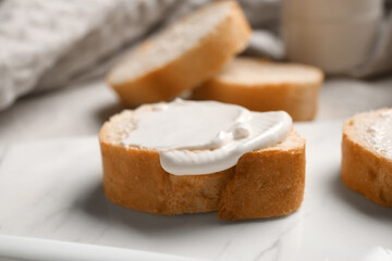 Board of tasty bruschetta with processed cheese on white background, closeup