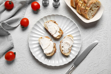 Plate of tasty bruschetta with processed cheese and fresh tomatoes on white background