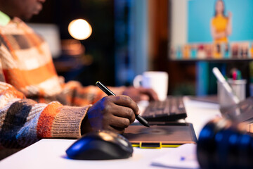 Freelance graphic designer working from home office on editing photos with advanced digital tools, showing the versatility of online work in the creative industry. Digital art retouching.