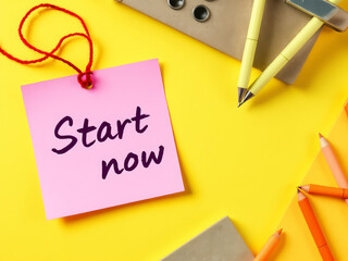 "Start Now" Motivational Sticky Note on Yellow Background