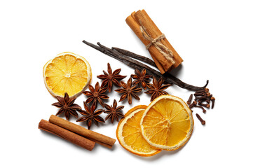 Anise stars with cinnamon, vanilla sticks and slices of dried orange on white background
