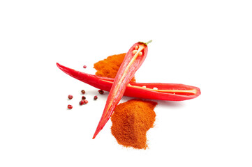 Heaps of red chili powder and cut pepper on white background