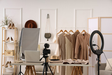 Interior of blogger's studio with workplace, clothes and accessories