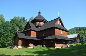 Wooden Church of the Nativity of the Blessed Virgin Mary dating in 1719 stands amidst lush green trees in a serene setting in Kryvorivnia village, Carpathian Mountains, Ukraine