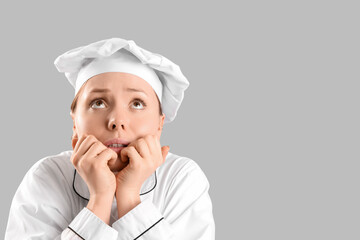 Female chef having panic attack on light background, closeup