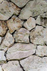 A wall made of white limestone, background and texture