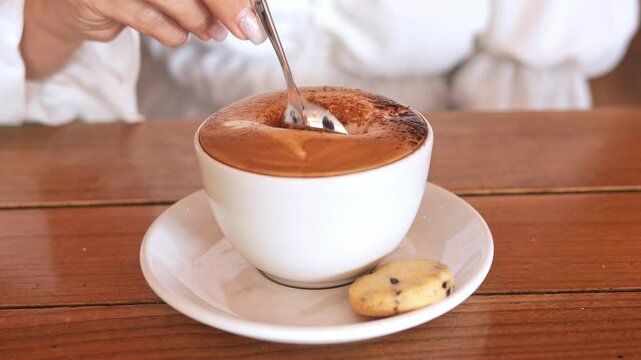 Captivating latte art on frothy cappuccino Coffee culture meets artistry in warm caft setting where skilled barista crafts intricate design on velvety foam elevating experience Coffee theme concept