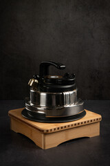 A pressure cooker against a black background