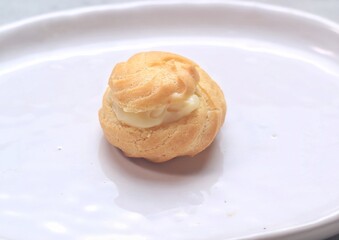 one soes cake (Choux Pastry Cream Puff)  served in a plate.
