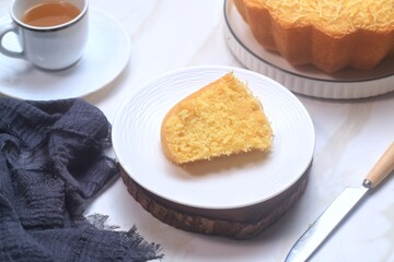 a slice of cake Tape or Fermented Cassava Cake in white plate cake on white background
