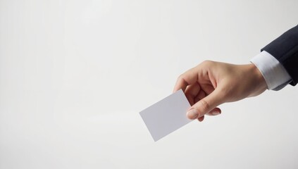 Hand offering blank business card, white background