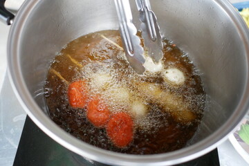 Fry the meatballs in a pot of oil.