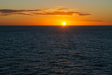 Sunset over the Pacific Ocean, with the sun slowly continuing to set.