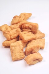 Tahu pong is a type of hollow tahu goreng (fried tofu) cut into small pieces. Use to make Fried Vegetable Tofu. Or usually called tahu sumedang. Isolated on White Background.
