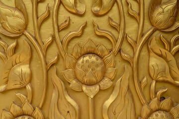 Gold carved wood temple door weathered and cracked from years of use