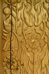 Gold carved wood temple door weathered and cracked from years of use