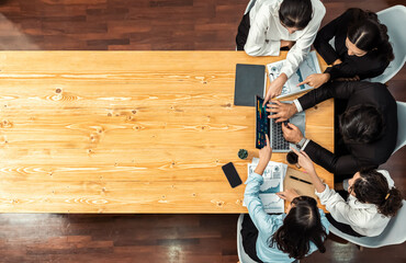 Panorama top view diverse group of business analyst team analyzing financial data report paper on meeting table. Chart and graph dashboard by business intelligence analysis. Meticulous