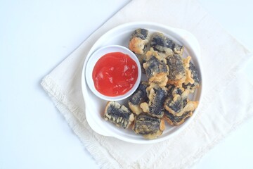 Chicken Nori Seaweed Roll is chicken dough with spices rolled in seaweed, then fried. served with sauce. Isolated on white plate
