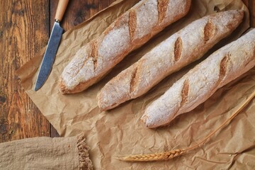 fresh cut baguettes on the wodden tray with butter. sourdough baguettes. healthy food.
